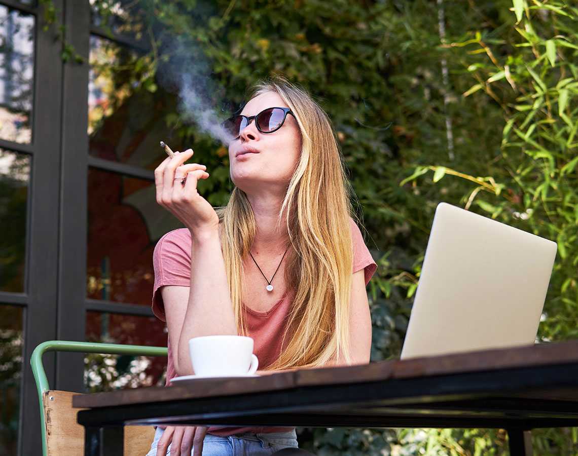 Woman With Glasses Smoking A Joint