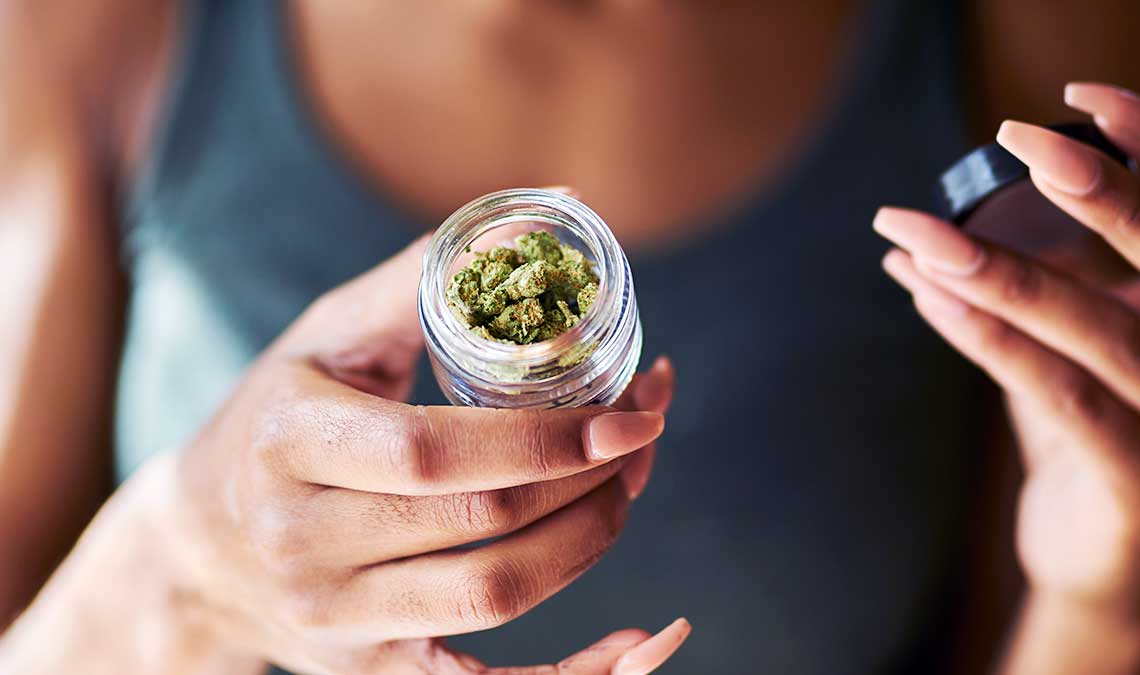 Woman Holding A Mini Jar Of Weed